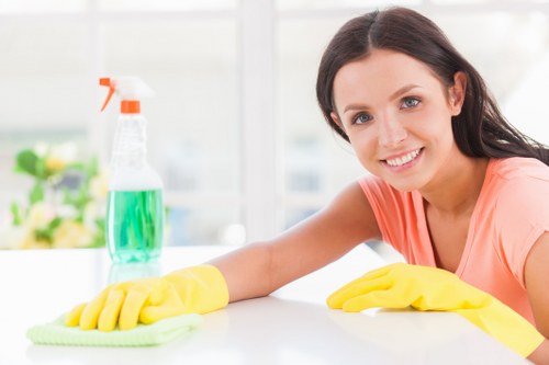 Technician preparing sofa cleaning equipment in a safe home setting