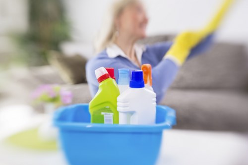 Technician wearing PPE during deep sofa cleaning work