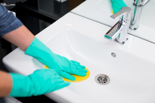 Professional carpet cleaner treating a busy home carpet in a local property